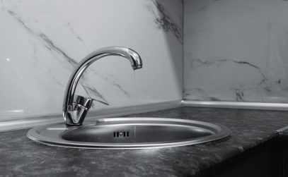 Kitchen sink with clogged drain needing professional cleaning
