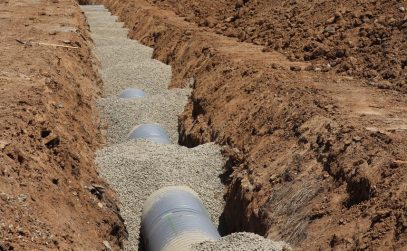 French drain installation with gravel-filled trench