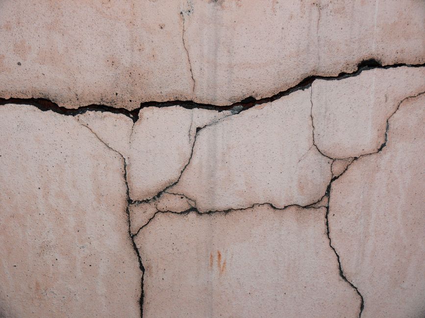 Foundation showing signs of water damage from poor drainage