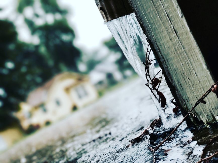 Downspout discharging heavy rainfall during New Orleans storm